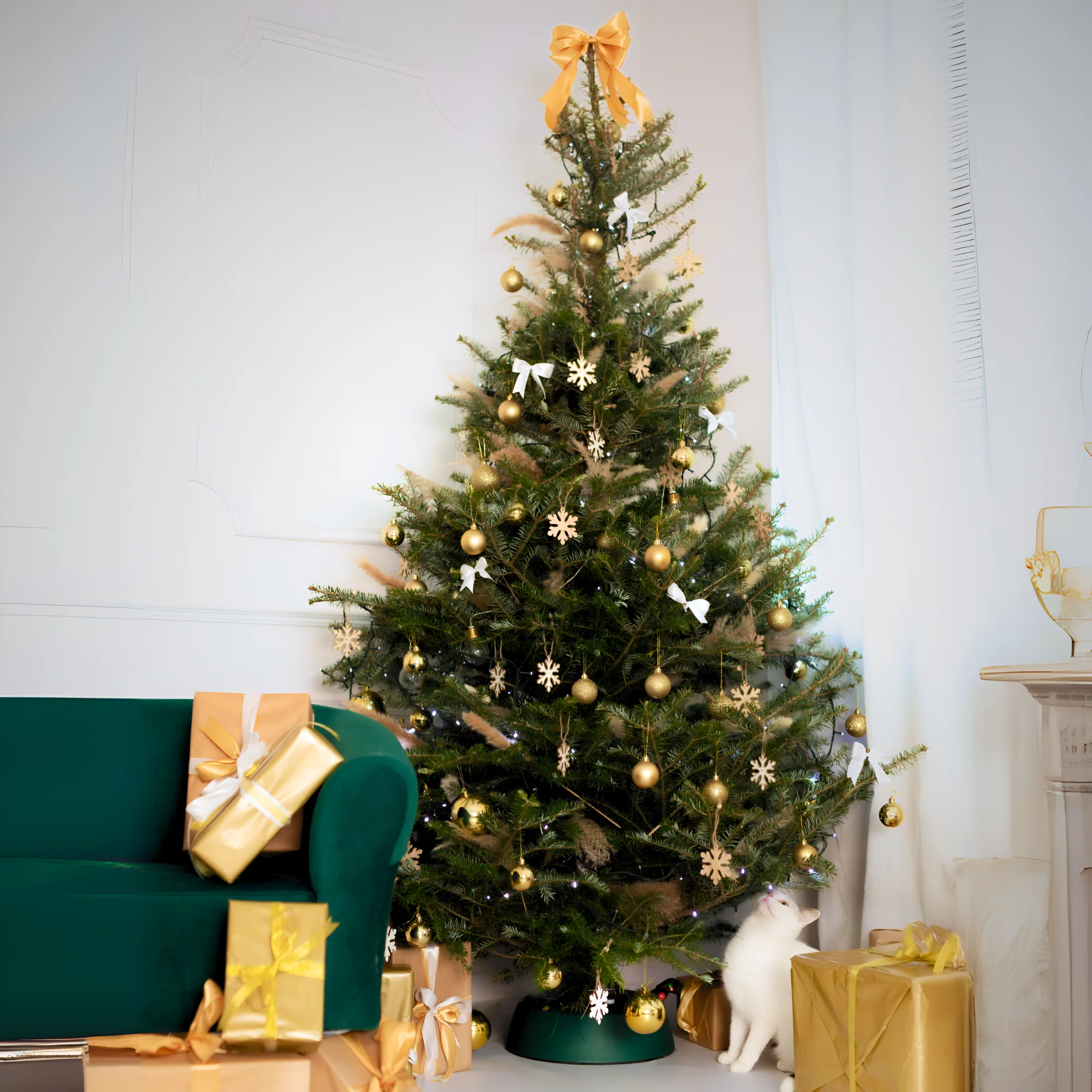 Decorated real Christmas tree in a green KAMAI START stand, with a green armchair and presents beside it